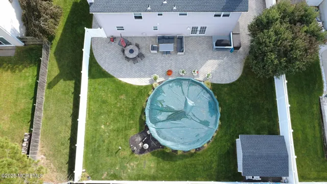 a view of a chairs and table in the back yard