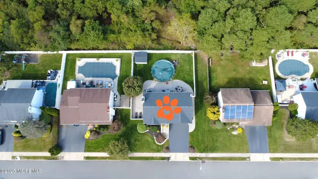 an aerial view of house with swimming pool outdoor seating and yard
