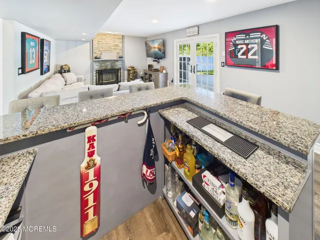 a view of a hallway with wooden floor and furniture