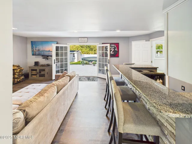 a bathroom with a granite countertop sink a mirror and shower