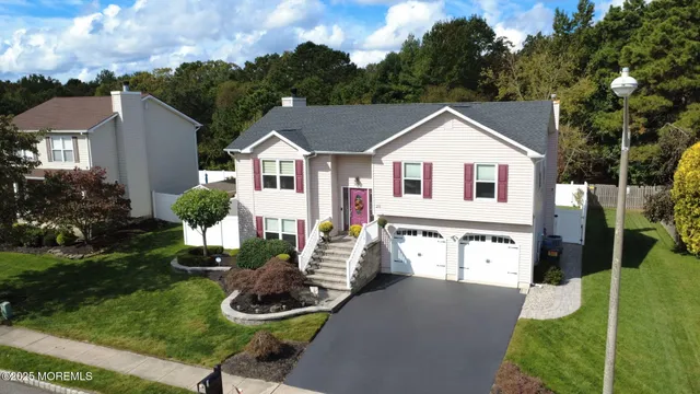 an aerial view of a house with swimming pool patio and outdoor seating