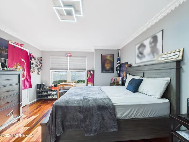 a large bed sitting in a bedroom next to a window