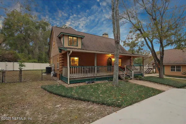 a view of a porch with furniture and wooden floor