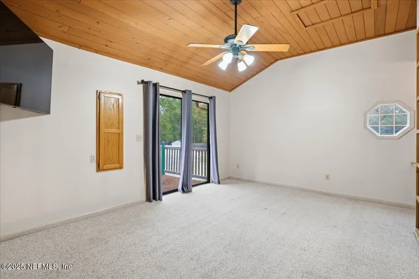 a view of a house with large trees and playing area