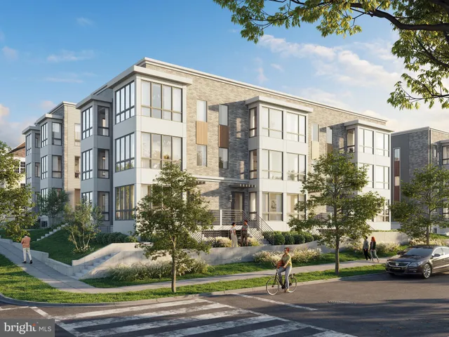 a front view of a residential apartment building with a yard