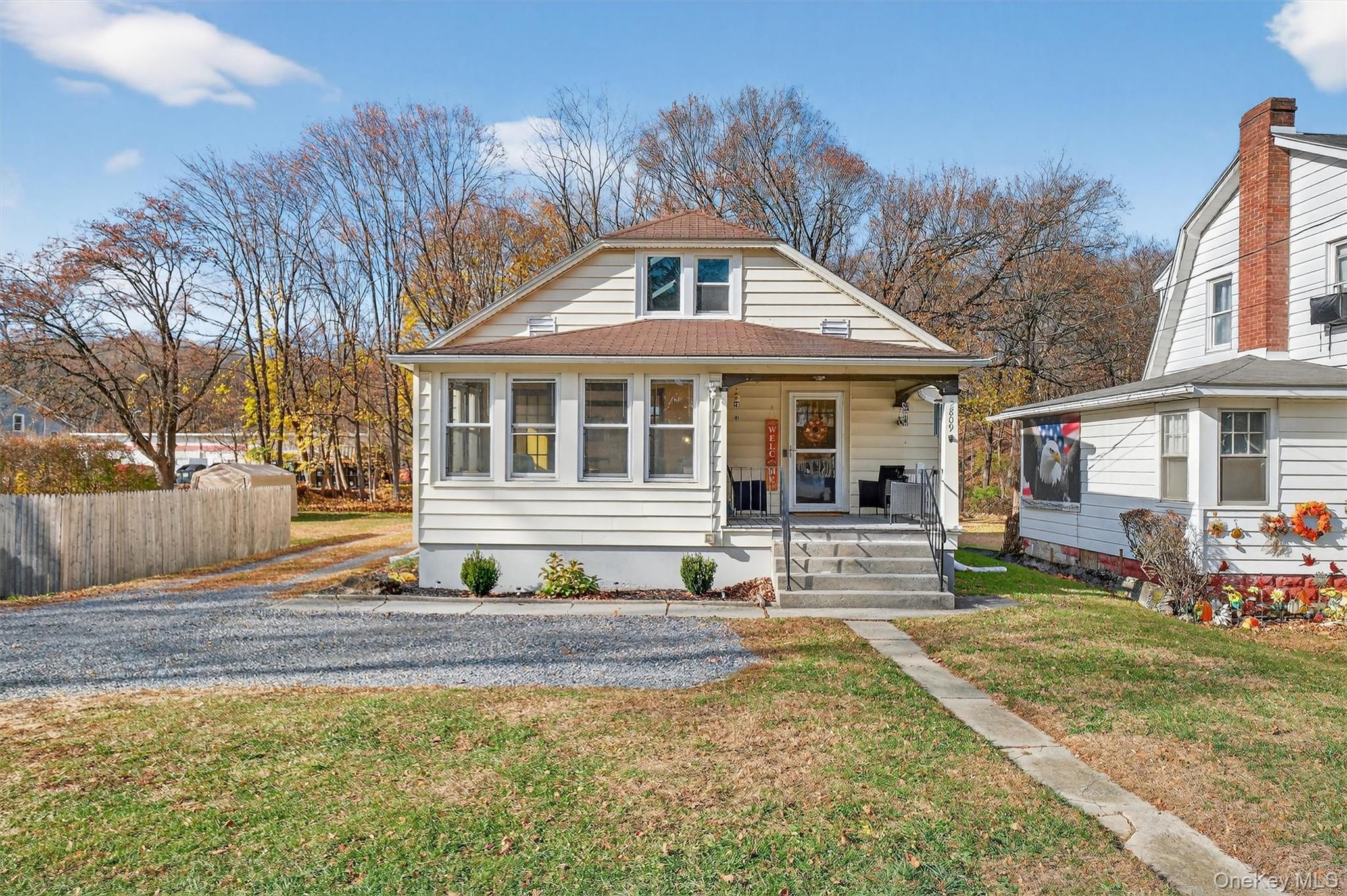 Bungalow-style home with covered porch and roof with shingles
