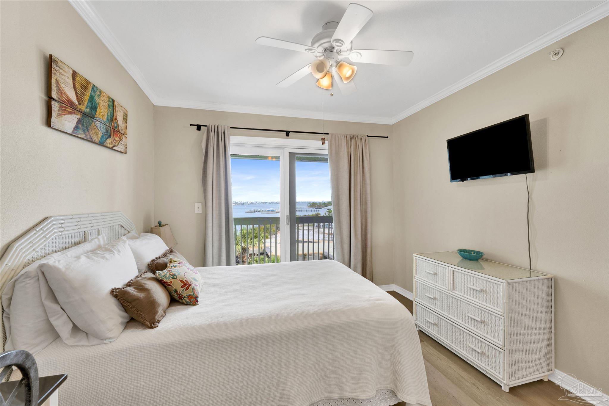 16310 Perdido Key Drive, Unit 12C Perdido Key, FL 32507 - Photo 15 of 32 a bedroom with a bed and a flat screen tv