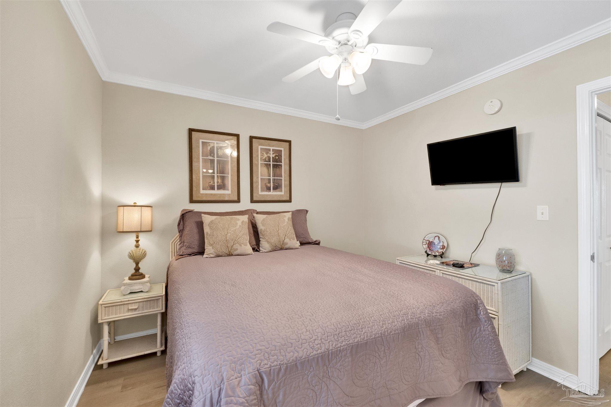 16310 Perdido Key Drive, Unit 12C Perdido Key, FL 32507 - Photo 18 of 32 a bedroom with a bed a window and a flat screen tv