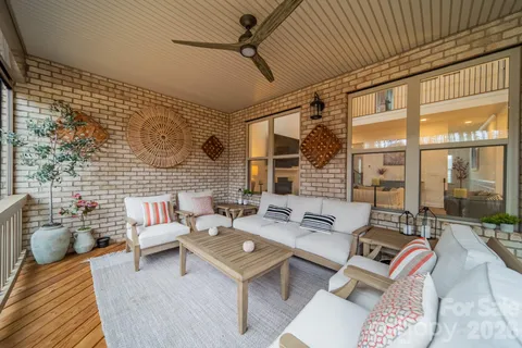 a living room with patio furniture and a floor to ceiling window