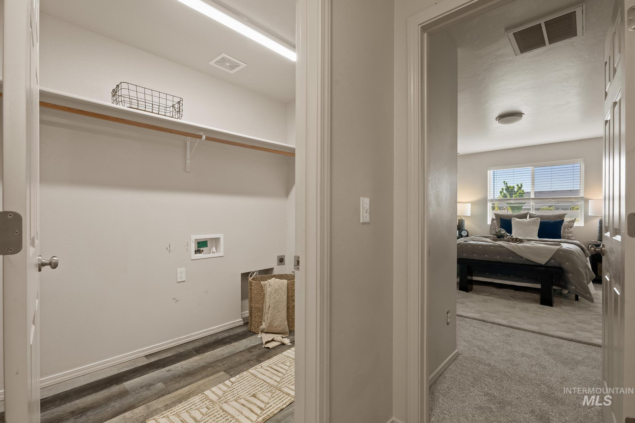 5506 Barkley Way Caldwell, ID 83607 - Photo 26 of 34 Dedicated laundry area featuring wood-finish flooring, overhead shelving, and a clothing rod