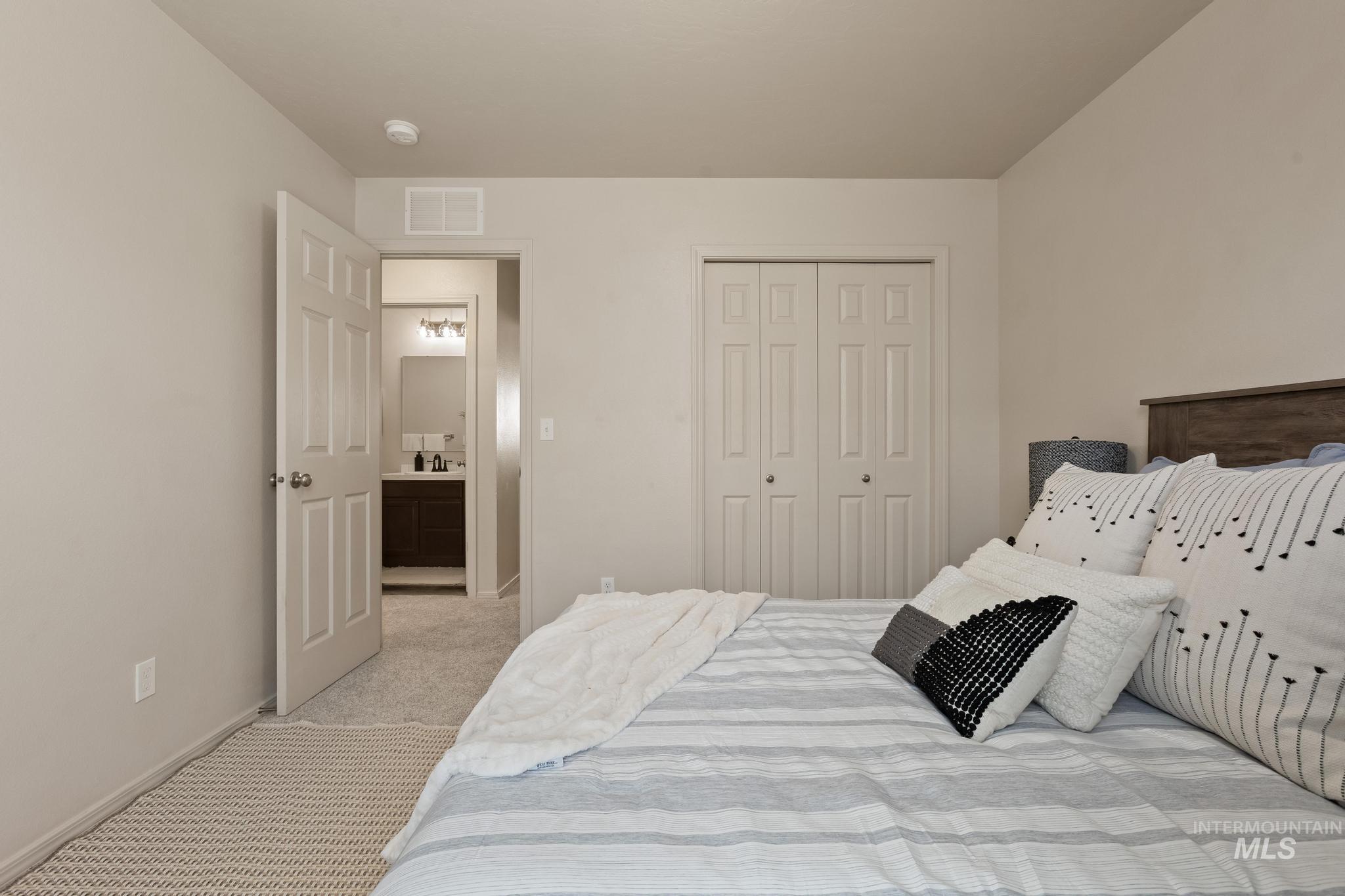 5506 Barkley Way Caldwell, ID 83607 - Photo 28 of 34 Carpeted bedroom featuring a double-door closet with paneling