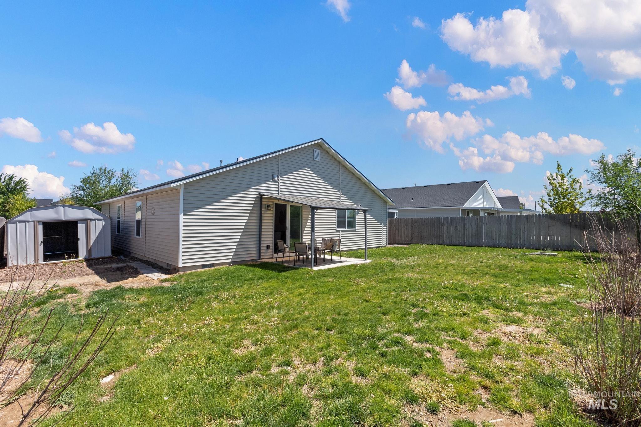5506 Barkley Way Caldwell, ID 83607 - Photo 32 of 34 Expansive backyard featuring a large grassy area and perimeter fencing