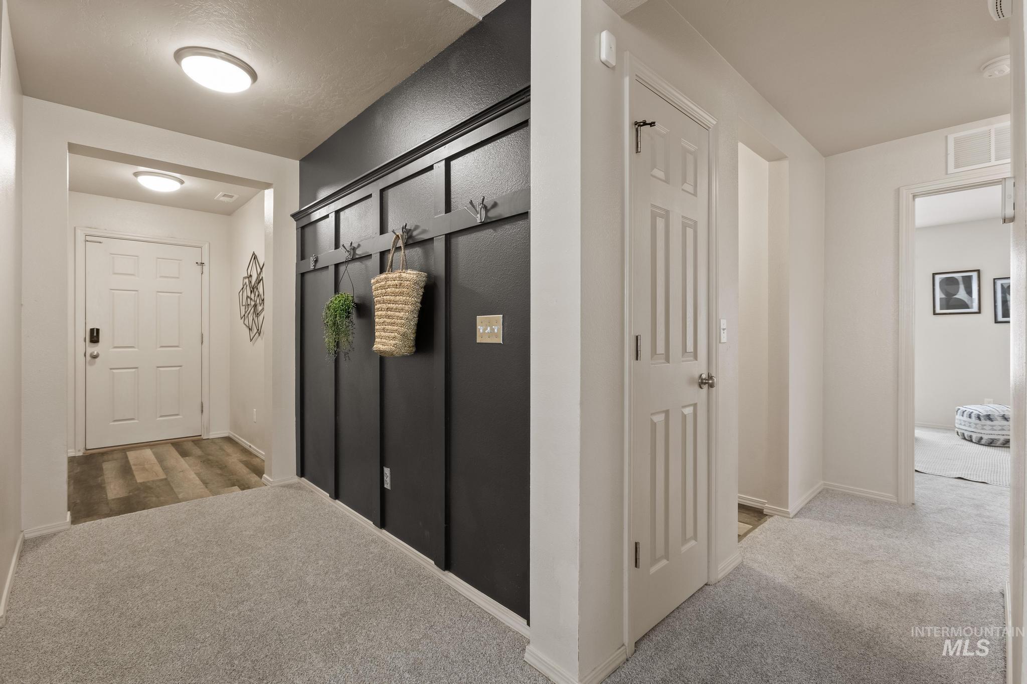 5506 Barkley Way Caldwell, ID 83607 - Photo 6 of 34 Entryway featuring a dark accent wall with board and batten detailing and integrated coat hooks