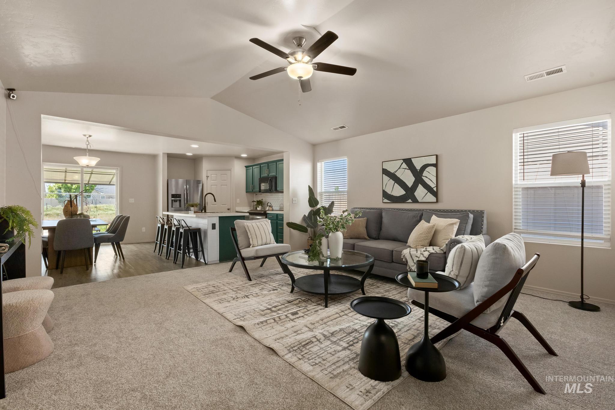5506 Barkley Way Caldwell, ID 83607 - Photo 7 of 34 Spacious living area featuring vaulted ceilings, light-toned carpeting, and multiple windows with blinds