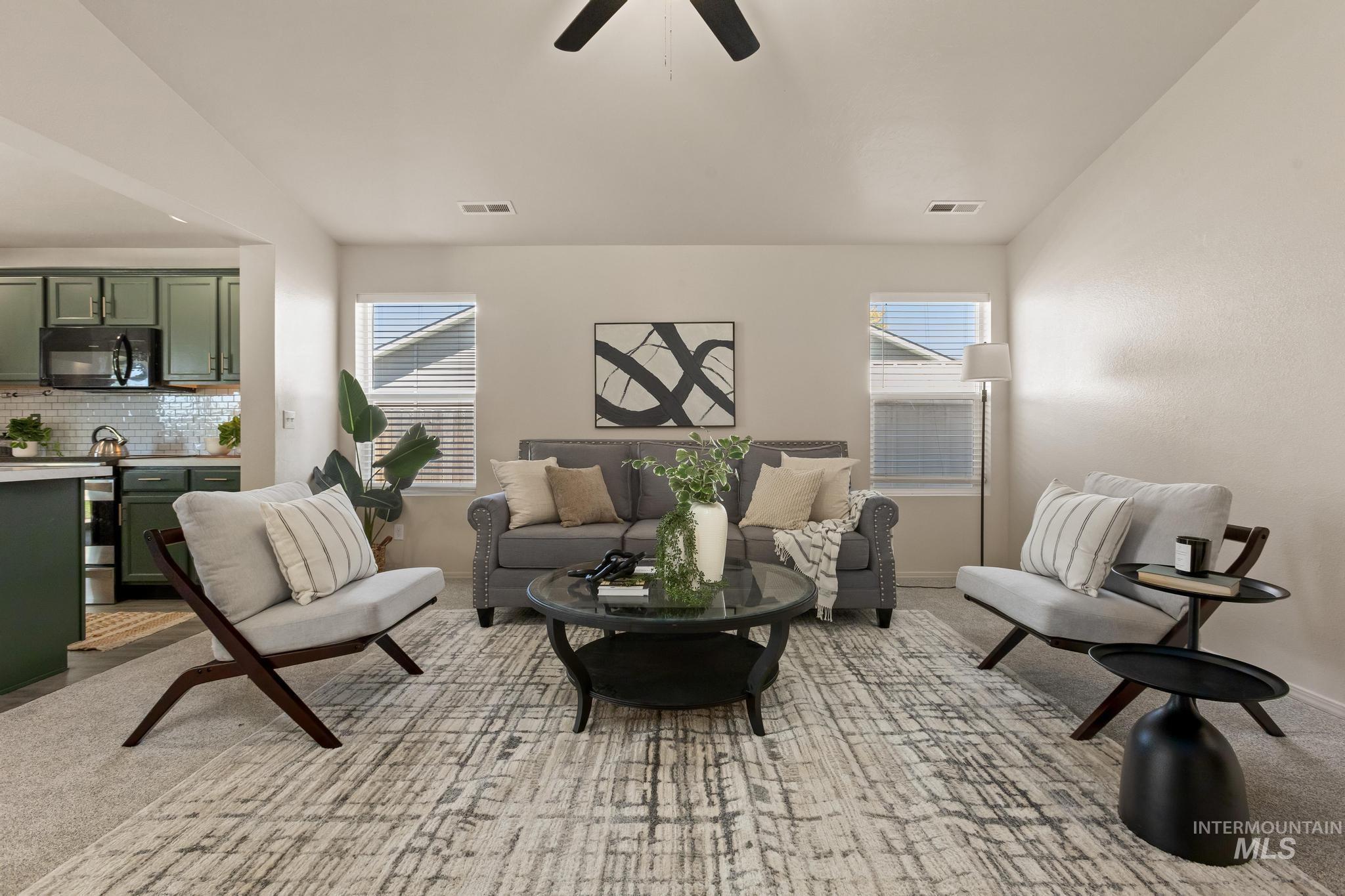 5506 Barkley Way Caldwell, ID 83607 - Photo 8 of 34 Open-concept living area featuring light-colored walls and a ceiling fan