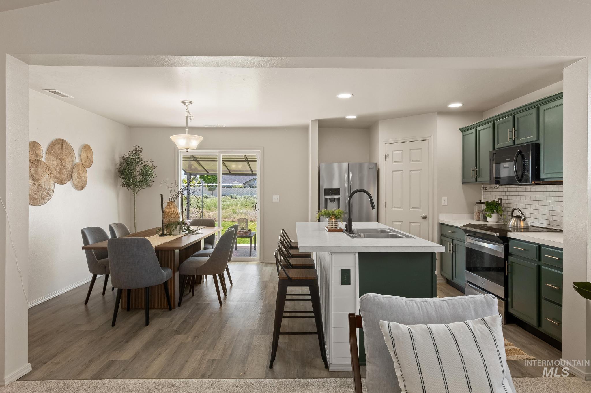 5506 Barkley Way Caldwell, ID 83607 - Photo 10 of 34 Open-concept living space featuring wood-finish flooring