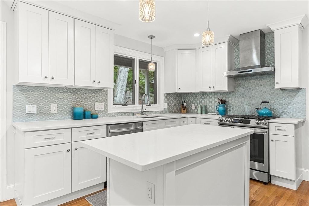 55 Redlands Road Boston, MA 02132 - Photo 11 of 42 a kitchen with white cabinets and white appliances