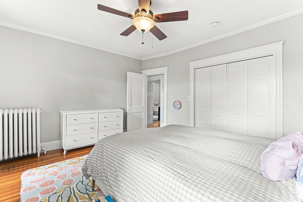 55 Redlands Road Boston, MA 02132 - Photo 19 of 42 a bedroom with a bed and a chandelier