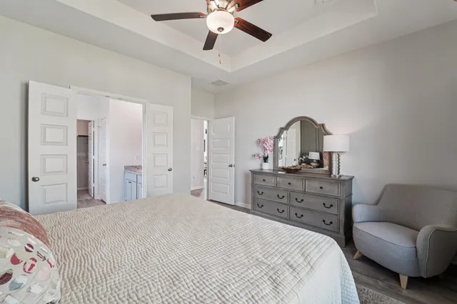 a bedroom with a bed and ceiling fan