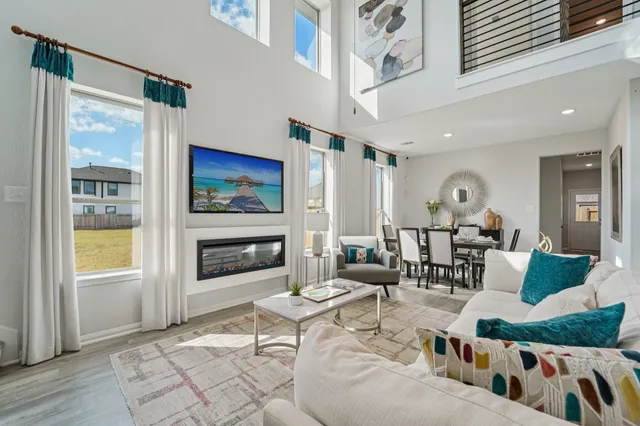 a living room with furniture fireplace and flat screen tv