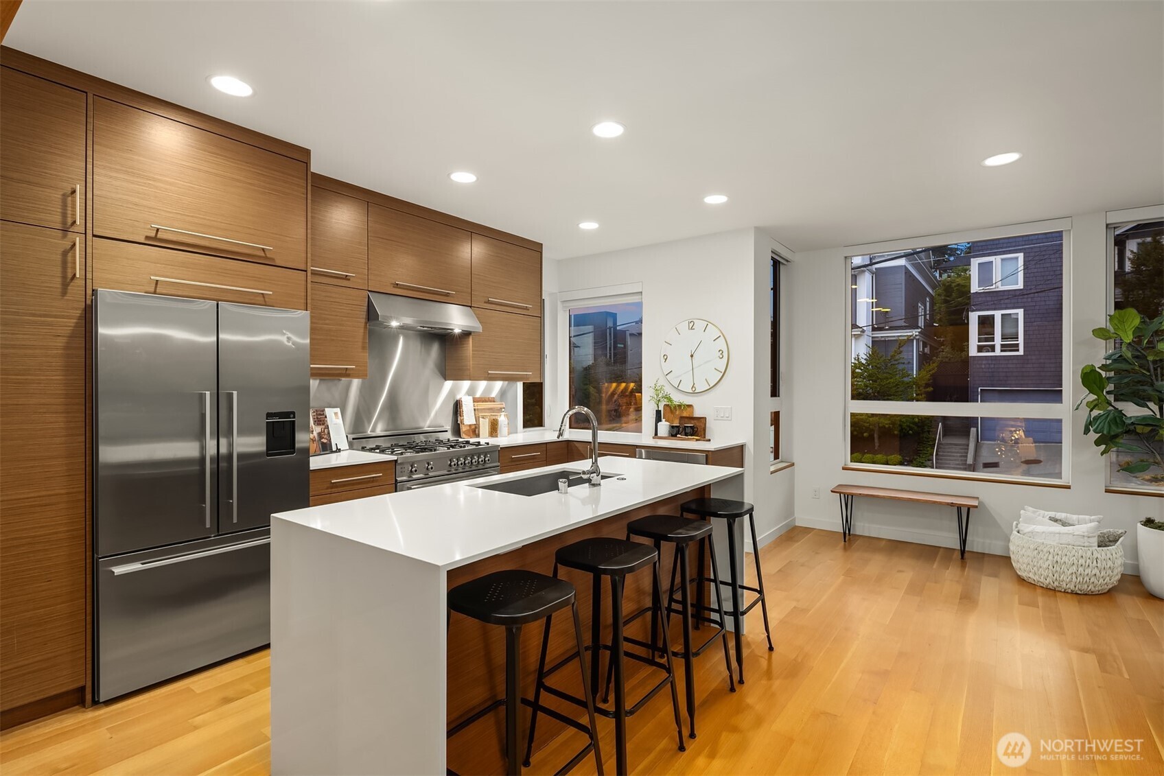 1002 5th Avenue North Seattle, WA 98109 - Photo 16 of 40 a kitchen with stainless steel appliances granite countertop a sink and a refrigerator