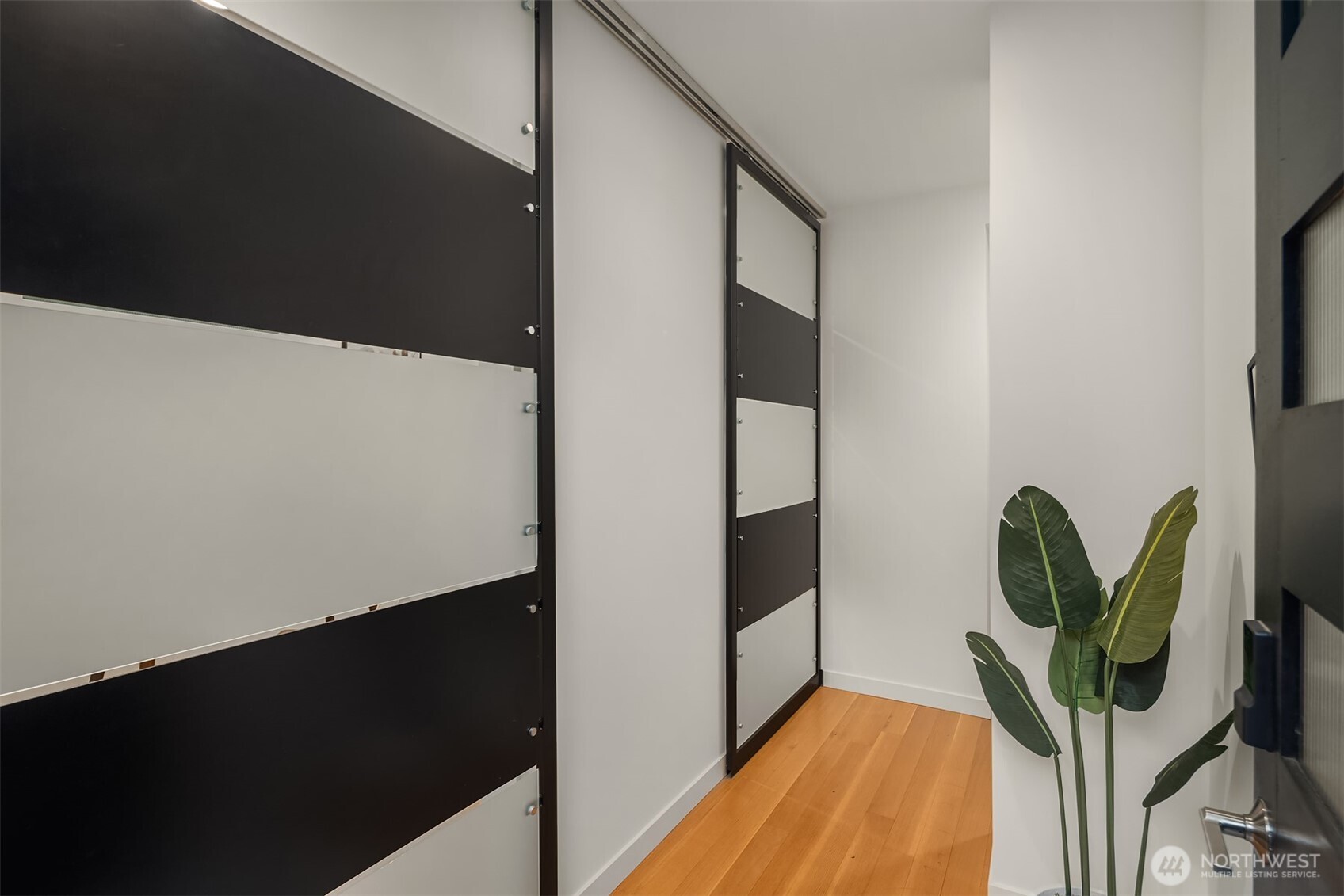 1002 5th Avenue North Seattle, WA 98109 - Photo 4 of 40 a view of a hallway with wooden floor