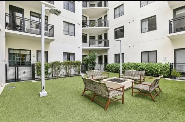 a swimming pool with outdoor seating and a garden