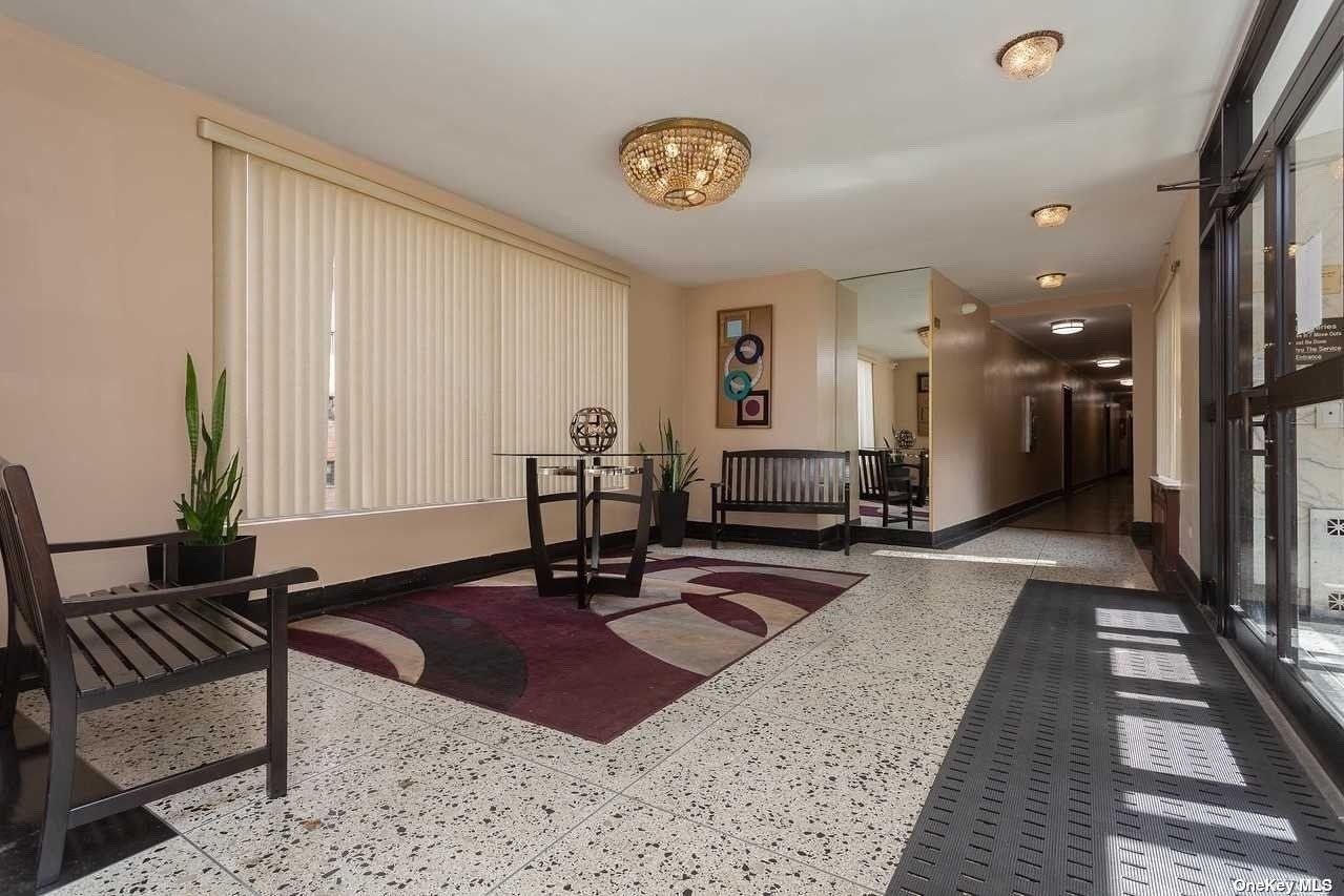a lobby with furniture and rug