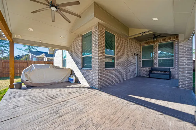 a view of a house with a wooden deck
