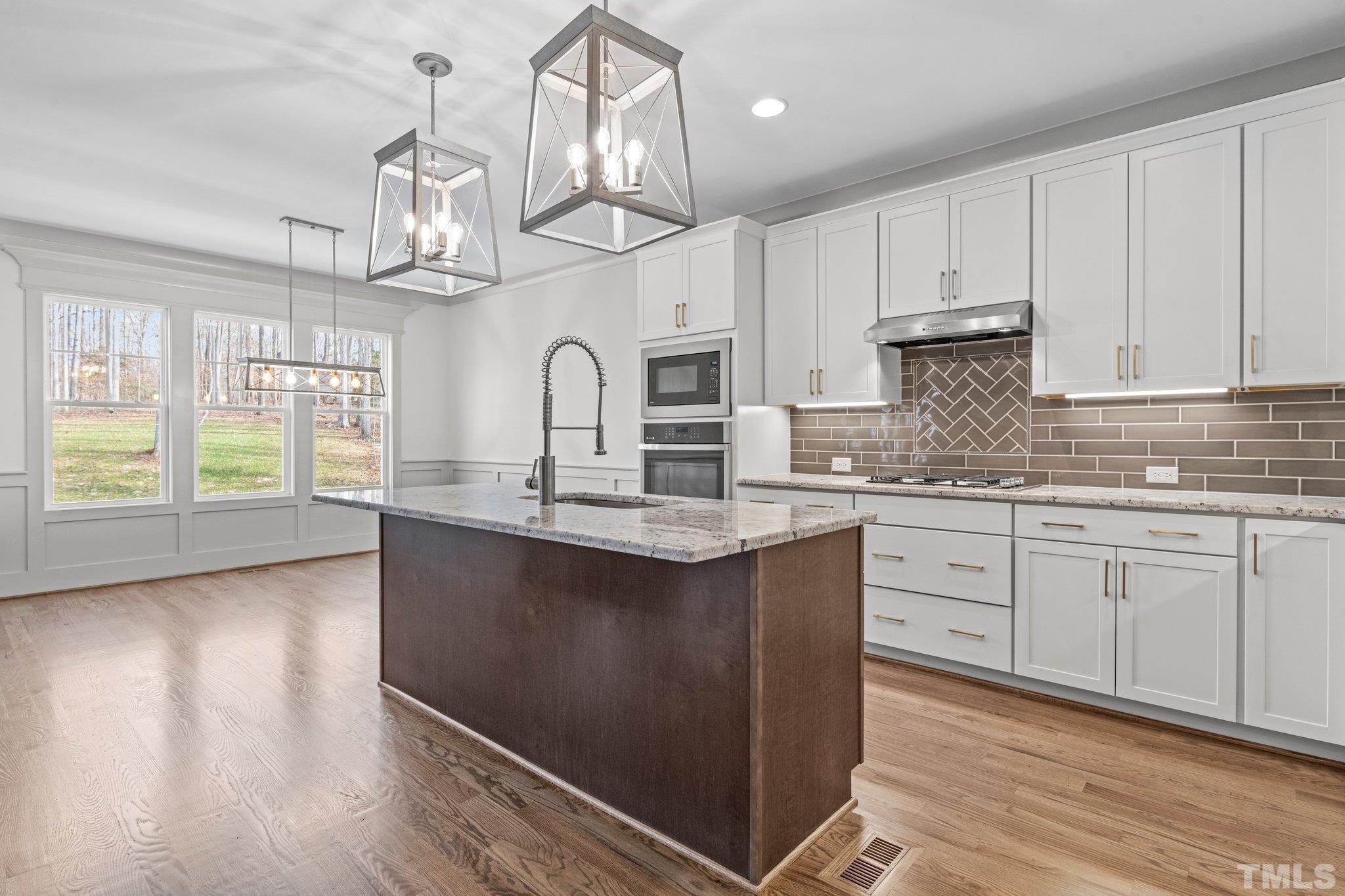 456 Reese Drive Willow Spring, NC 27592 - Photo 11 of 50 a kitchen with stainless steel appliances granite countertop a sink a stove a refrigerator cabinets and living room view