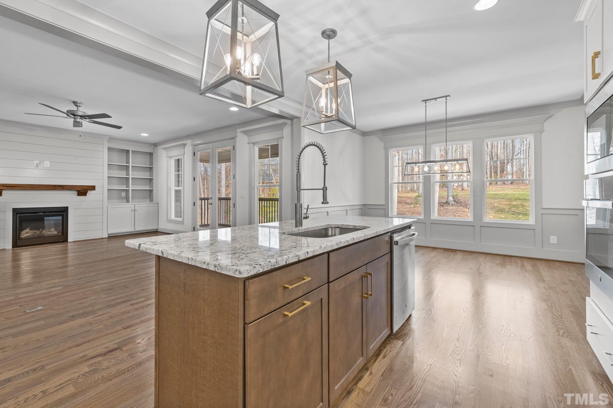 456 Reese Drive Willow Spring, NC 27592 - Photo 13 of 50 a large kitchen with granite countertop a stove oven and a wooden floor