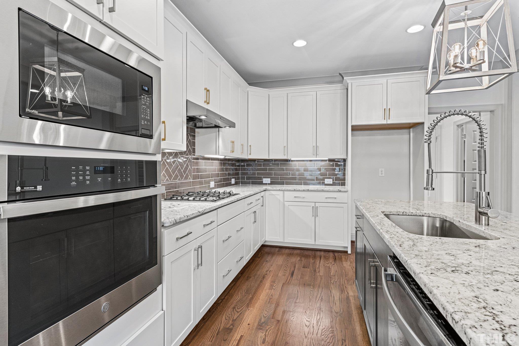 456 Reese Drive Willow Spring, NC 27592 - Photo 14 of 50 a kitchen with granite countertop cabinets stainless steel appliances and a sink