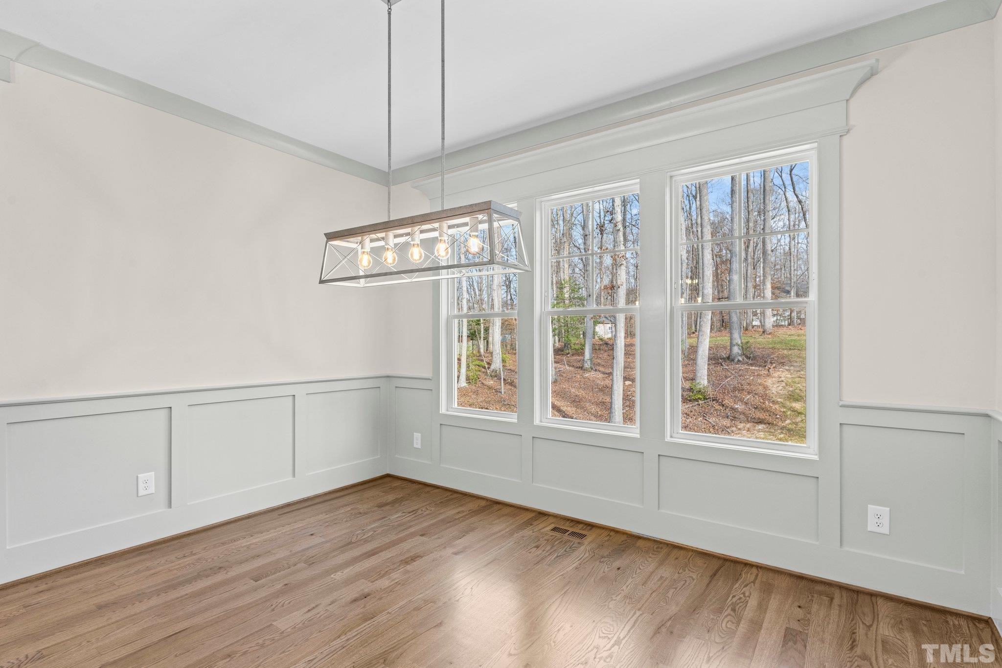 456 Reese Drive Willow Spring, NC 27592 - Photo 15 of 50 a view of an empty room with a window and hardwood floor