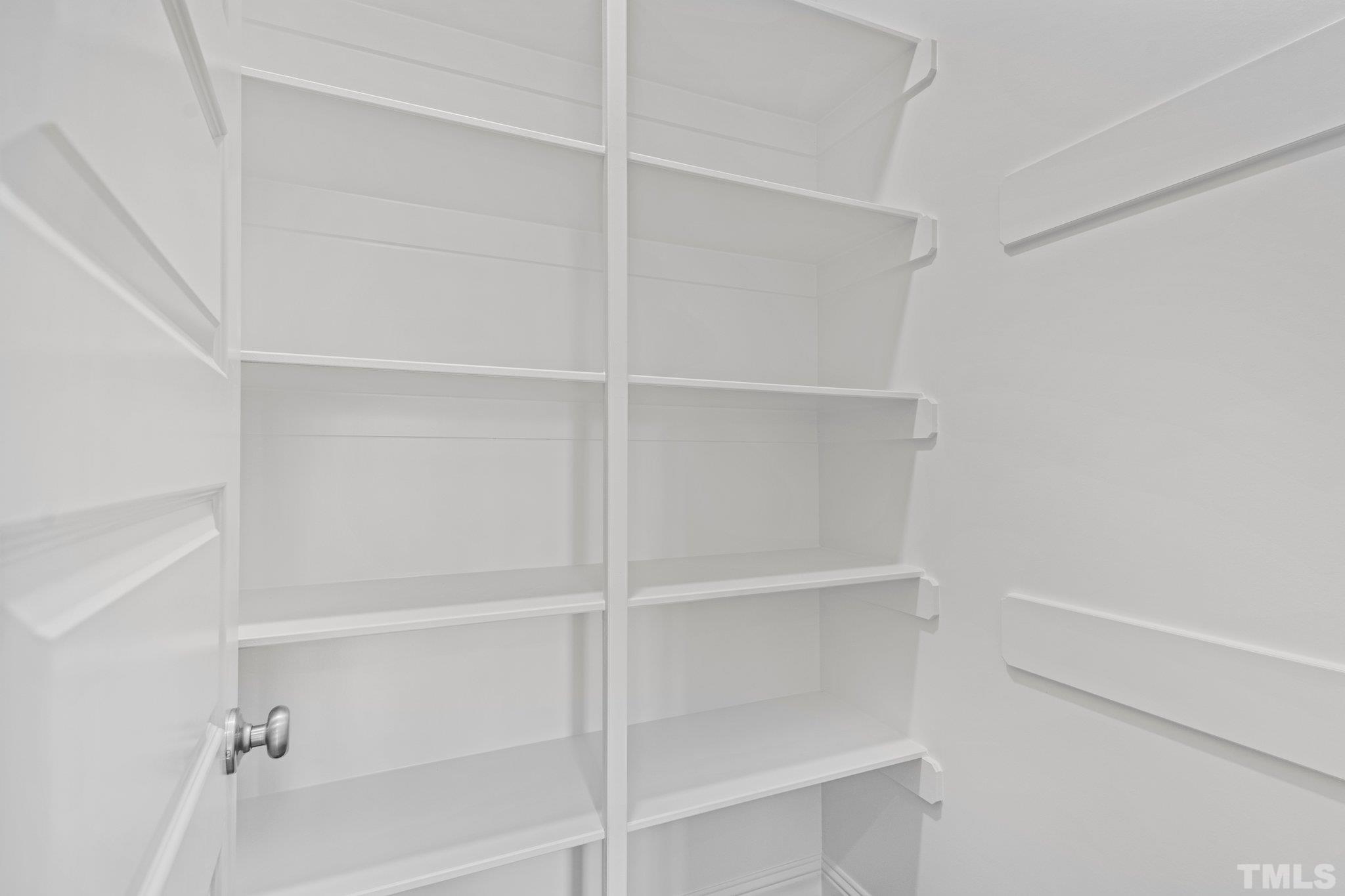 456 Reese Drive Willow Spring, NC 27592 - Photo 16 of 50 a view of walk in closet with empty racks