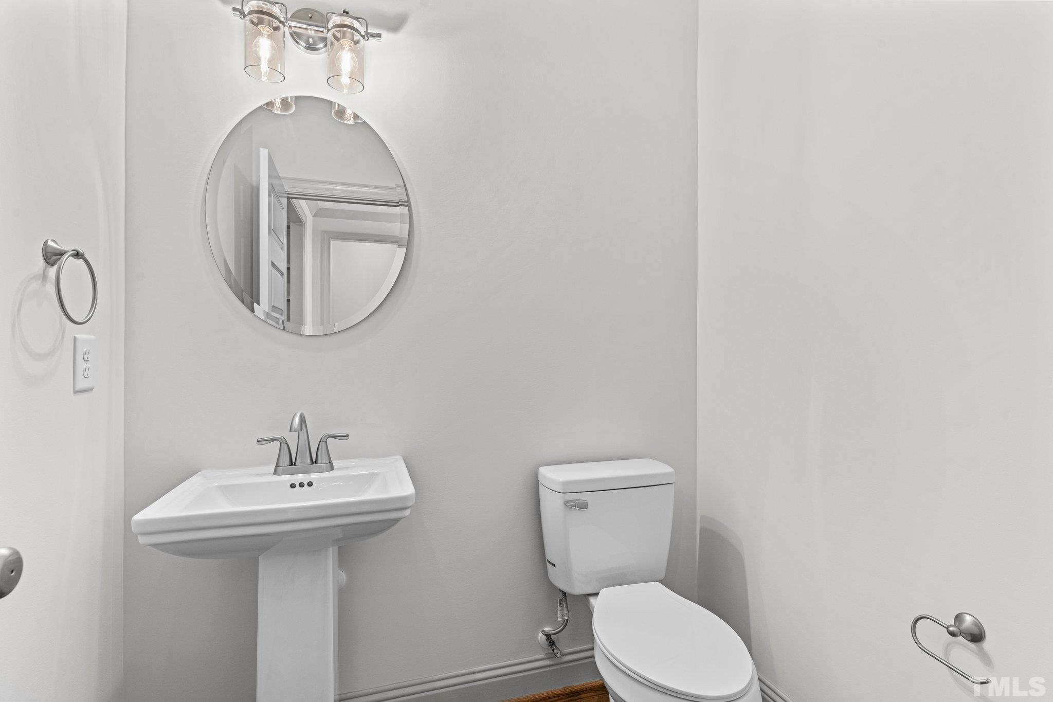 456 Reese Drive Willow Spring, NC 27592 - Photo 19 of 50 a bathroom with a toilet sink and mirror