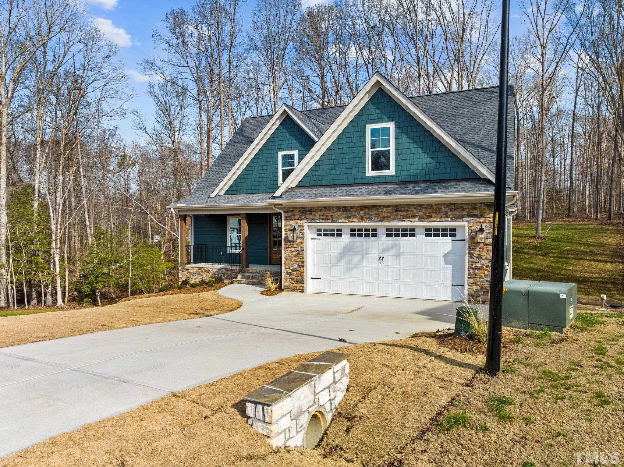 456 Reese Drive Willow Spring, NC 27592 - Photo 2 of 50 a front view of a house with a yard and garage