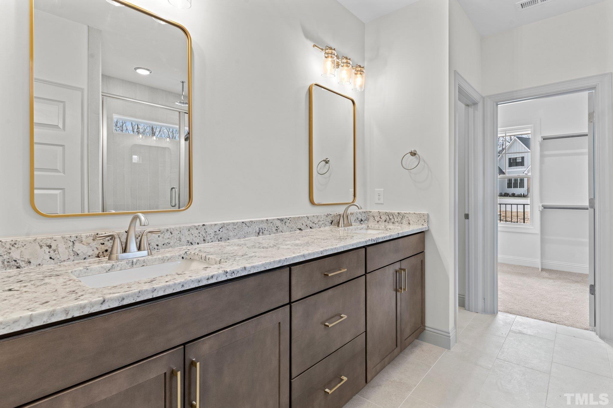 456 Reese Drive Willow Spring, NC 27592 - Photo 22 of 50 a bathroom with a granite countertop sink double and mirror