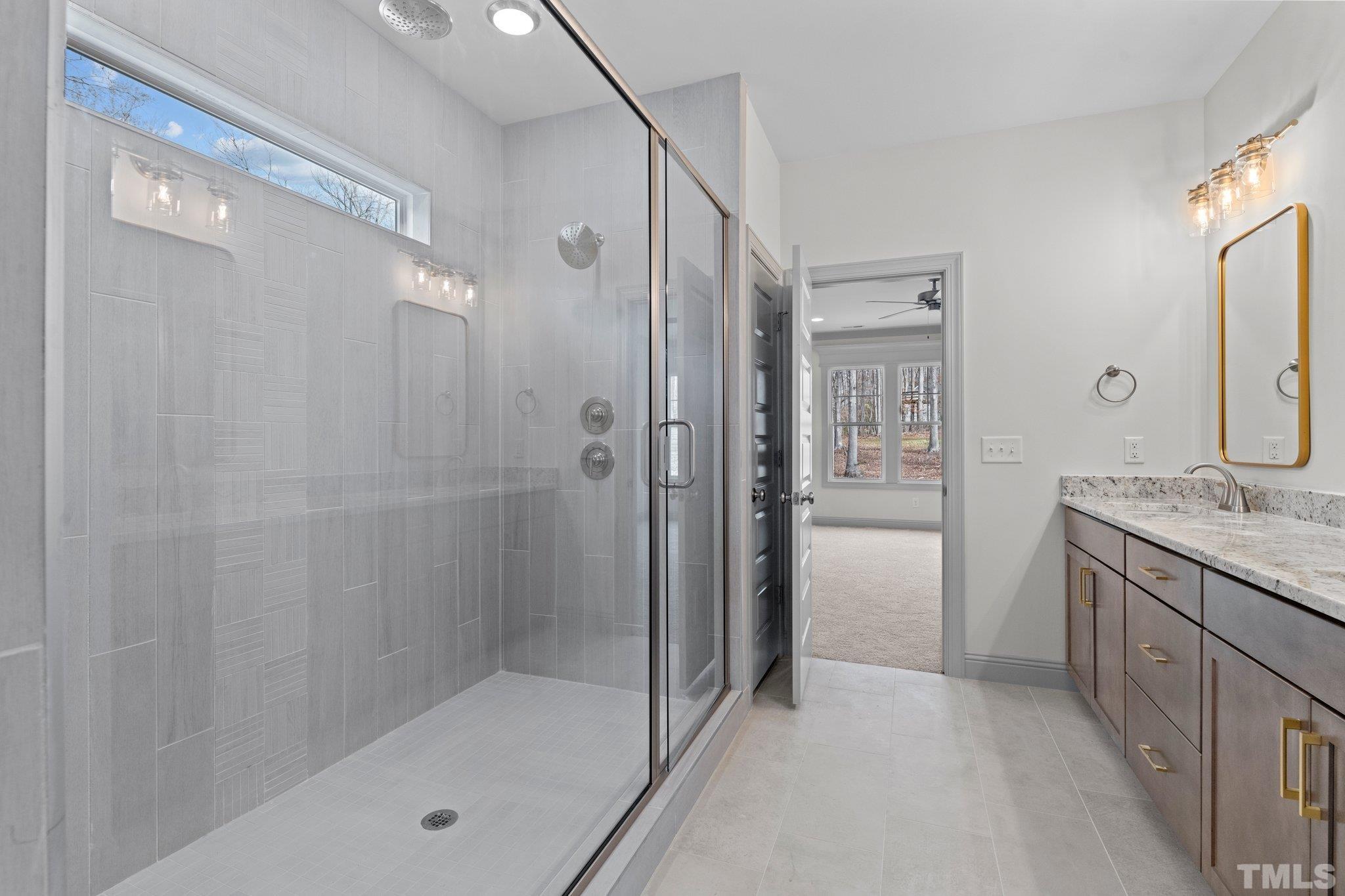 456 Reese Drive Willow Spring, NC 27592 - Photo 23 of 50 a bathroom with a granite countertop shower mirror and a bathtub