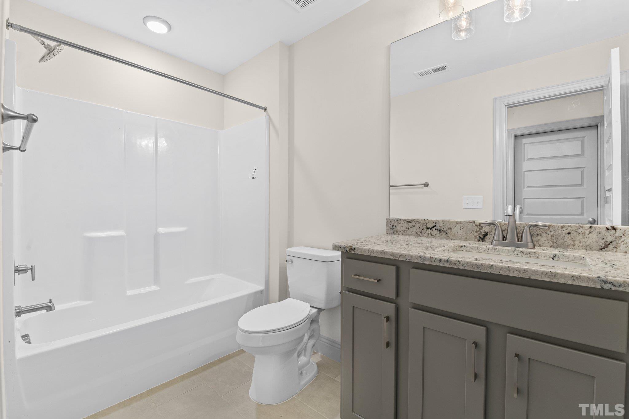 456 Reese Drive Willow Spring, NC 27592 - Photo 28 of 50 a bathroom with a granite countertop sink toilet and shower