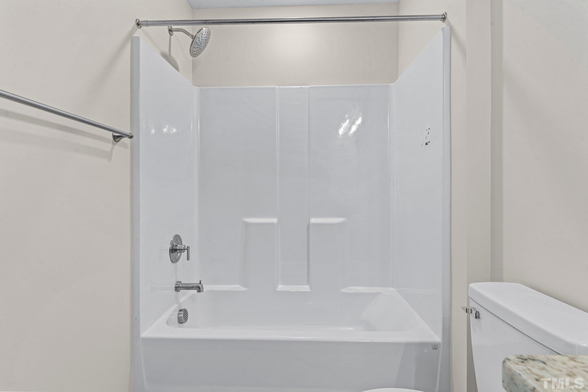 456 Reese Drive Willow Spring, NC 27592 - Photo 29 of 50 a bathroom with a bathtub and a shower