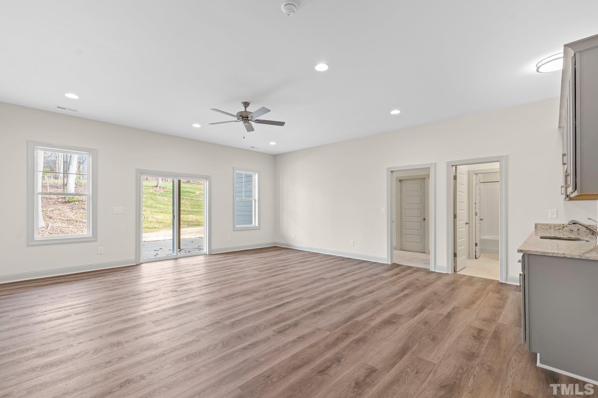 456 Reese Drive Willow Spring, NC 27592 - Photo 34 of 50 a view of an empty room with a window and wooden floor