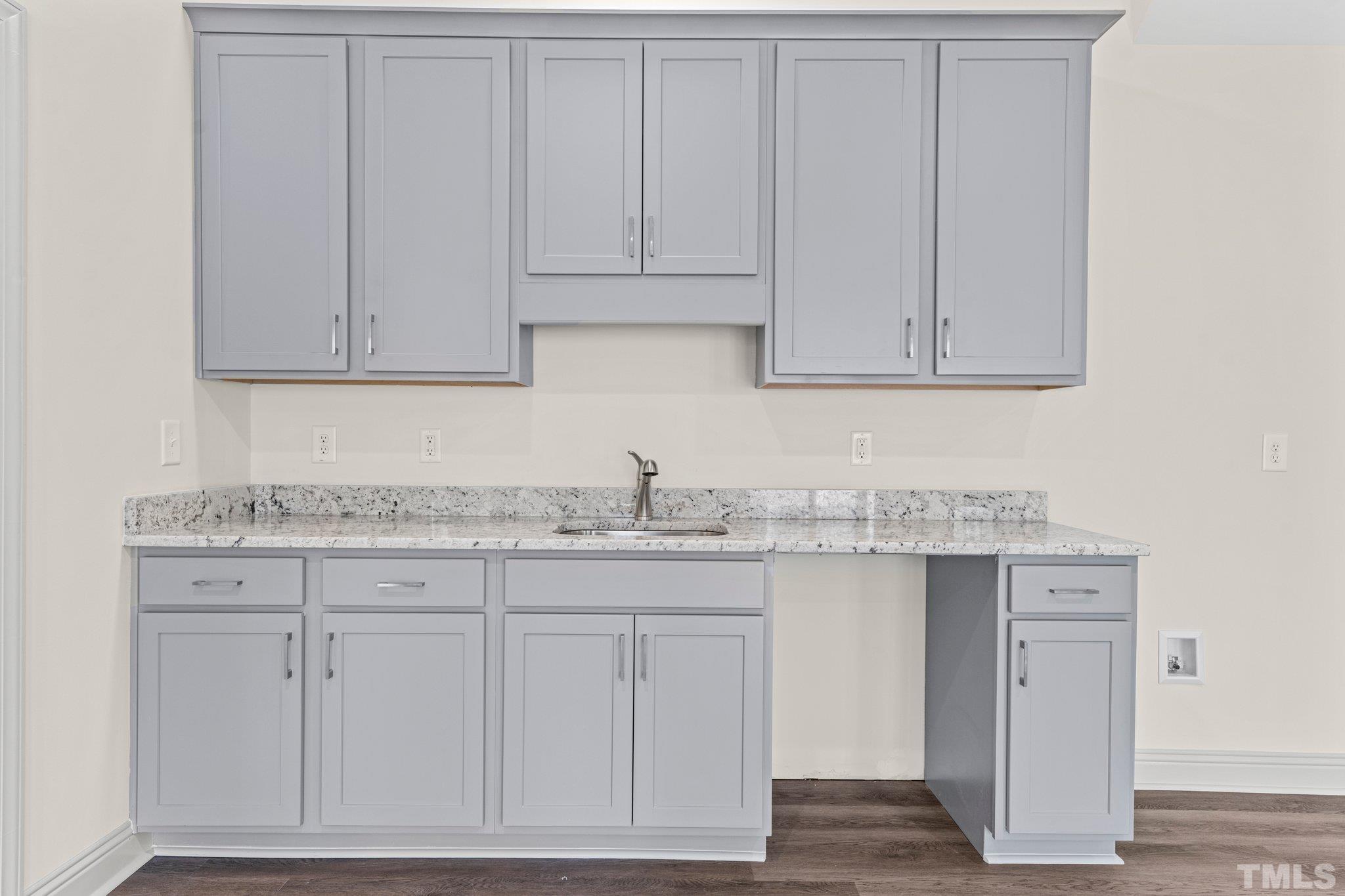 456 Reese Drive Willow Spring, NC 27592 - Photo 36 of 50 a kitchen with granite countertop white cabinets and sink