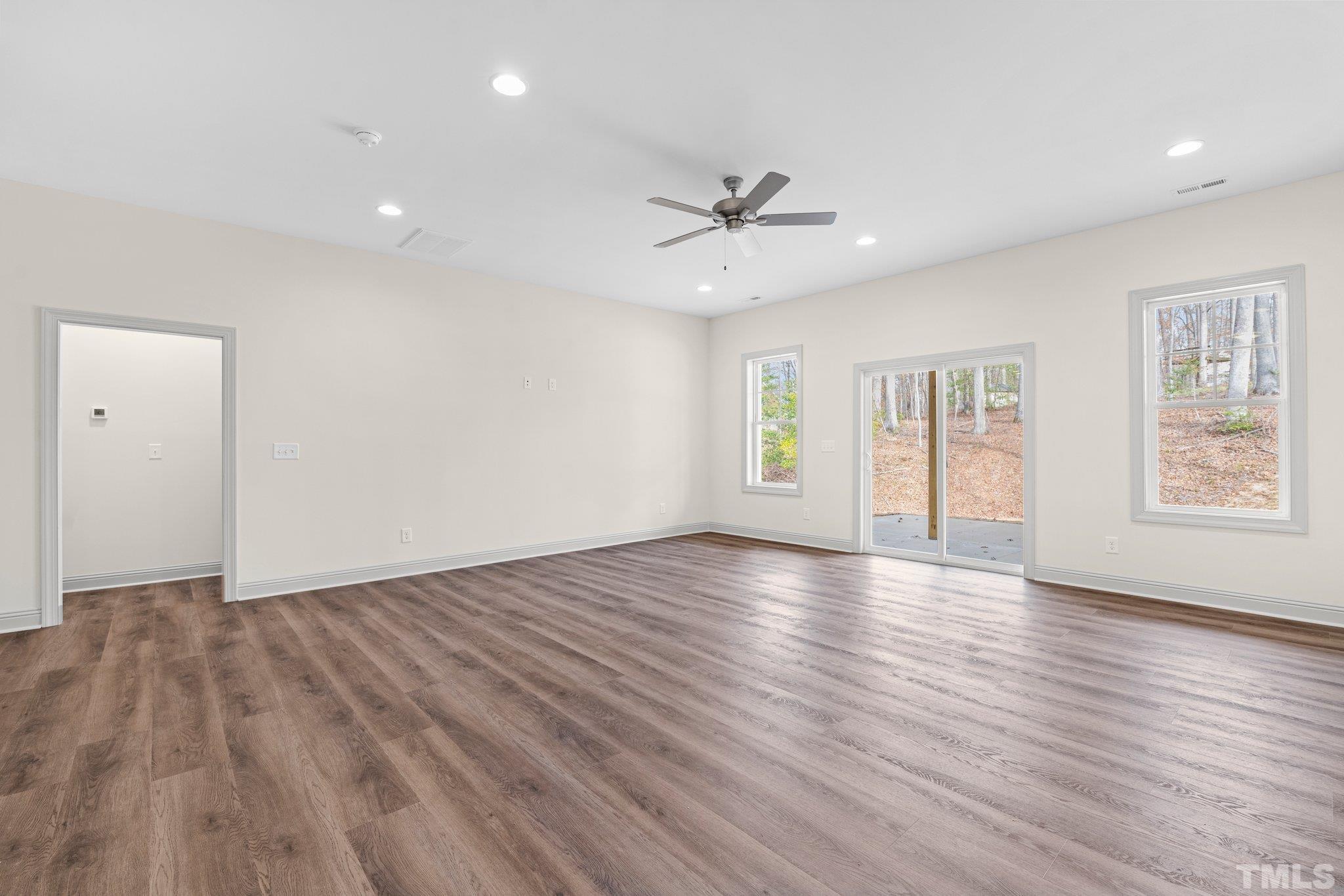 456 Reese Drive Willow Spring, NC 27592 - Photo 37 of 50 a view of an empty room with a window and wooden floor