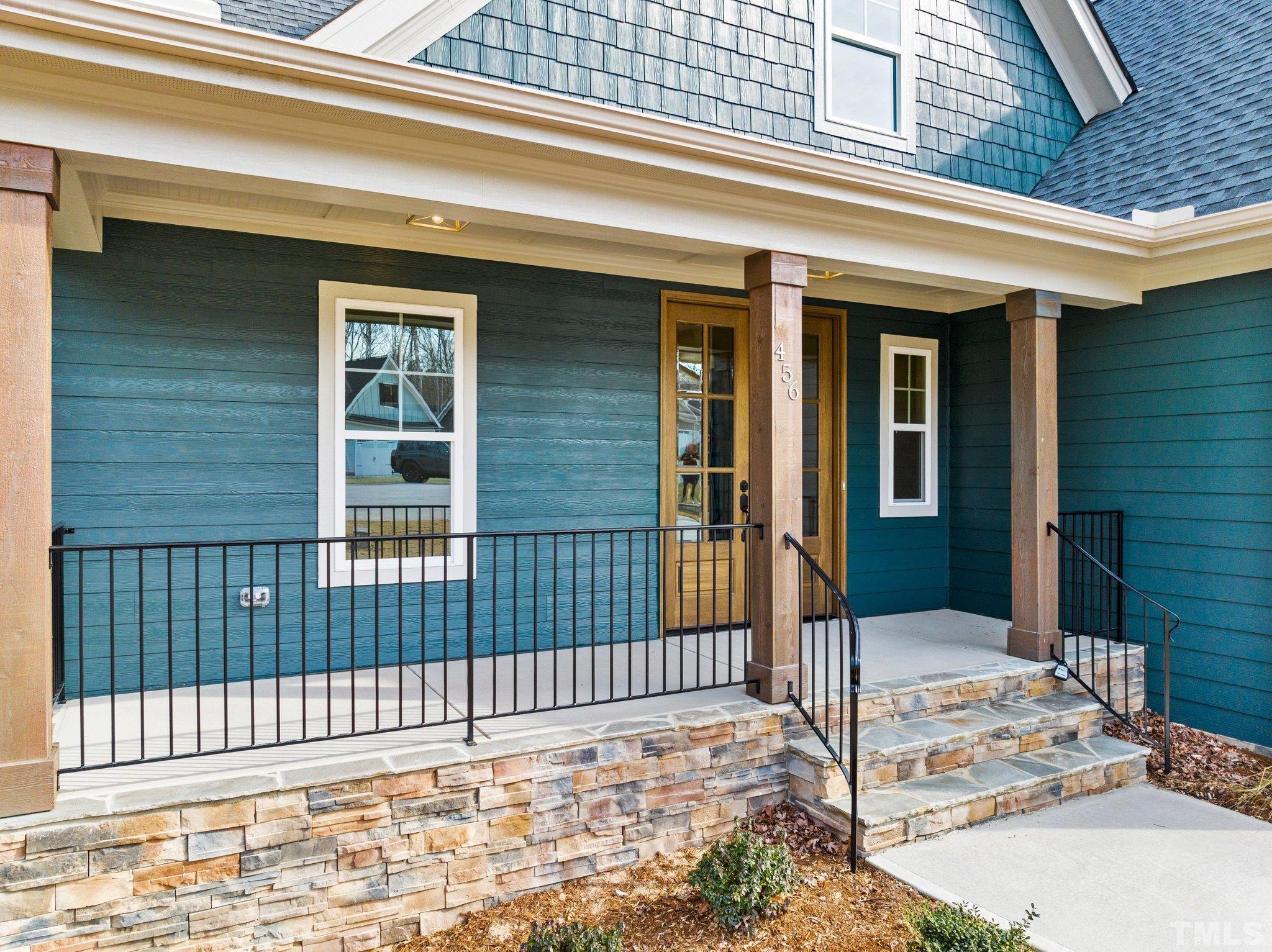 456 Reese Drive Willow Spring, NC 27592 - Photo 4 of 50 a view of a brick house with many windows