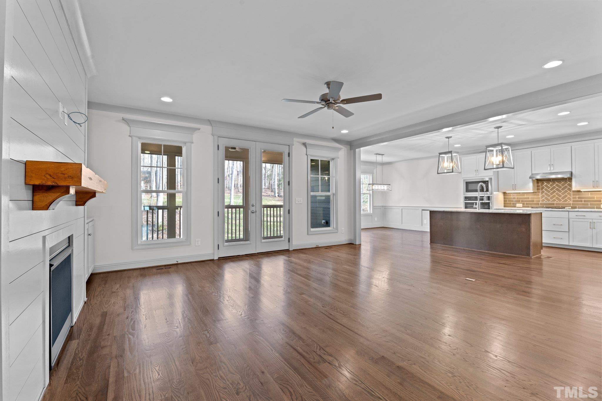 456 Reese Drive Willow Spring, NC 27592 - Photo 10 of 50 a view of an empty room with wooden floor and a window