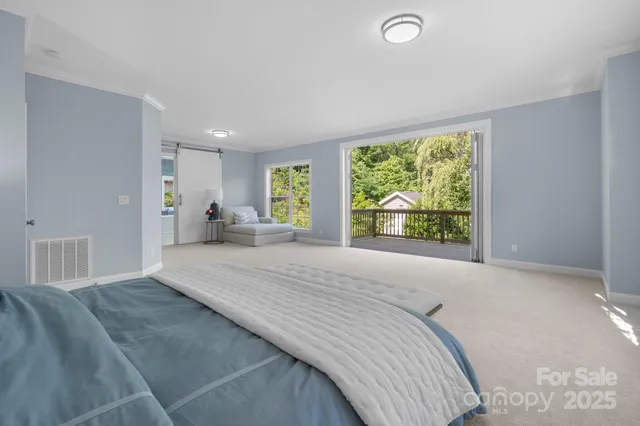 a bed room with a bed and a large window