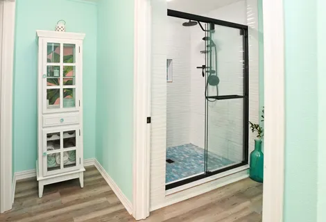 a bathroom with a toilet and a shower