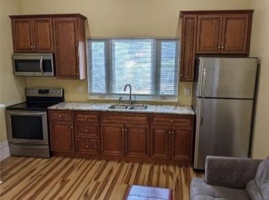 a kitchen with stainless steel appliances granite countertop a refrigerator a sink dishwasher a stove a microwave oven with granite countertops and cabinets