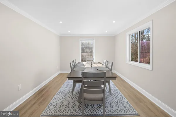 a view of a dining room with furniture and wooden floor
