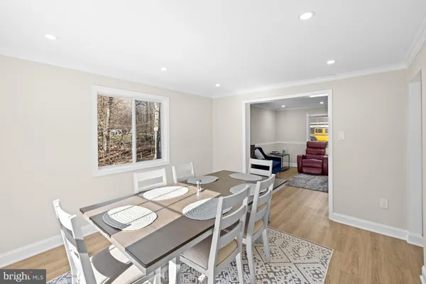 a view of a dining room with furniture and a wooden floor